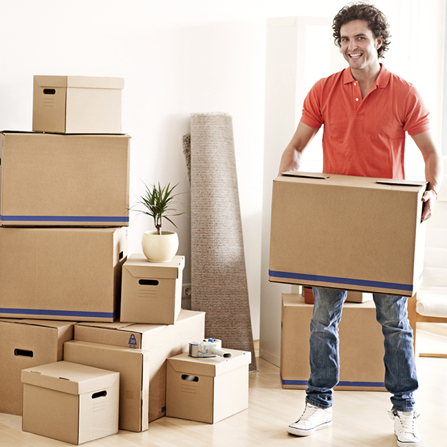 Photo: Stress Free Storage. Smiling man surrounded by boxes